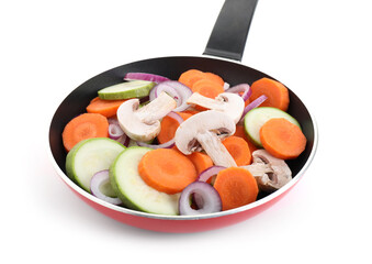 Frying pan with mix of fresh vegetables and mushrooms isolated on white