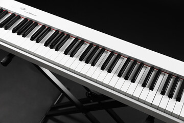 Synthesizer on black background, closeup. Electronic musical instrument