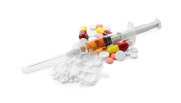 Drug addiction. Different pills, syringe and powder isolated on white