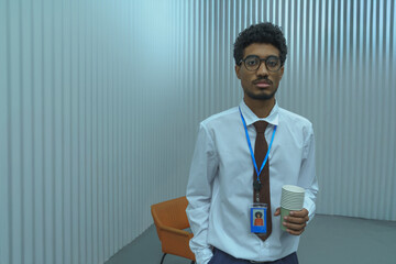 Professional Man Holding Disposable Coffee Cups