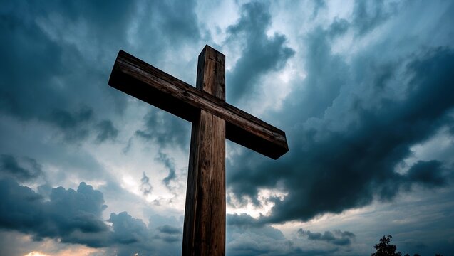 Majestic wooden cross silhouetted against dramatic clouds