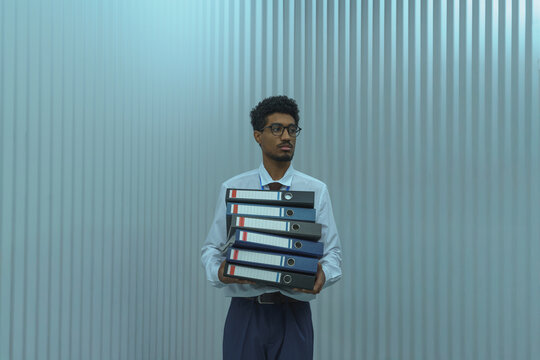 Professional Man Holding Stack of Binders