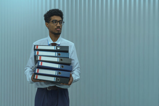 Businessman Holding Stack of Office Binders