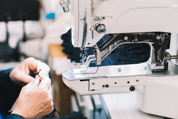 Sewing machine in use for garment production in a workshop