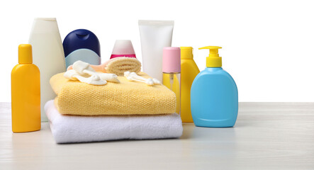 Baby cosmetic products and bath accessories on wooden table against white background