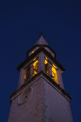 Illuminated Church Bell Tower at Night 