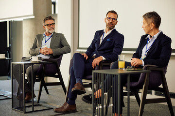 Businesspeople speak at the conference