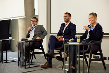 Businesspeople speak on stage