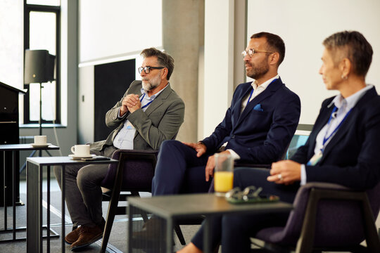 Businesspeople speak at the conference