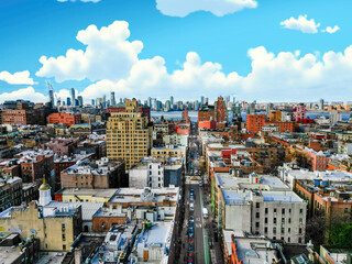Aerial view of a vibrant city neighborhood under a bright, sunny sky.