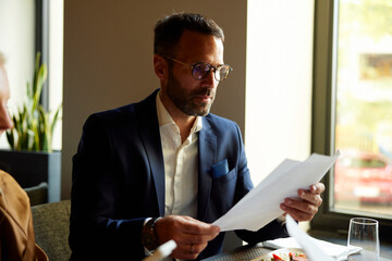 Man revises papers in the restaurant