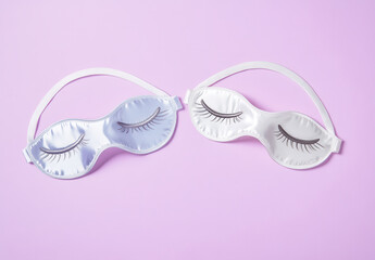 Sleep masks in blue and white on pastel background, perfect for relaxation