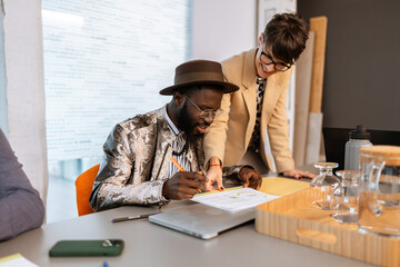 Managers working together on charts in modern coworking office