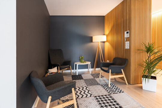 Modern coworking office waiting room with gray armchairs