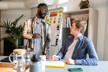 Two businessmen discussing strategy in coworking space