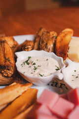 Assorted snacks with condiments served on a tray.