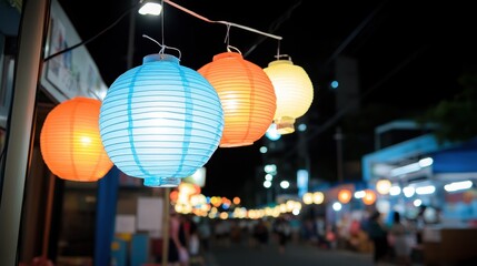 Fototapeta premium Colorful paper lanterns illuminating a night market ambiance
