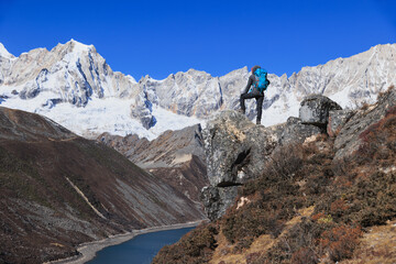 Fototapeta premium Successful woman hiking on high altitude mountain top