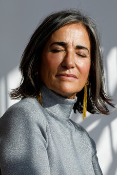 Woman with closed eyes poses gracefully