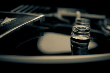 Close-up of a guitar knob in monochrome with smooth reflections.