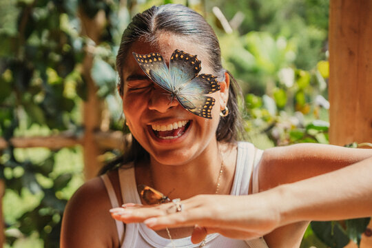Cheerful woman with butterflies in her face