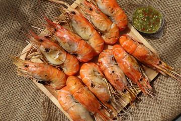 Top View. grilled shrimp on a wooden board and side dish Seafood dipping sauce. Types of grilled...