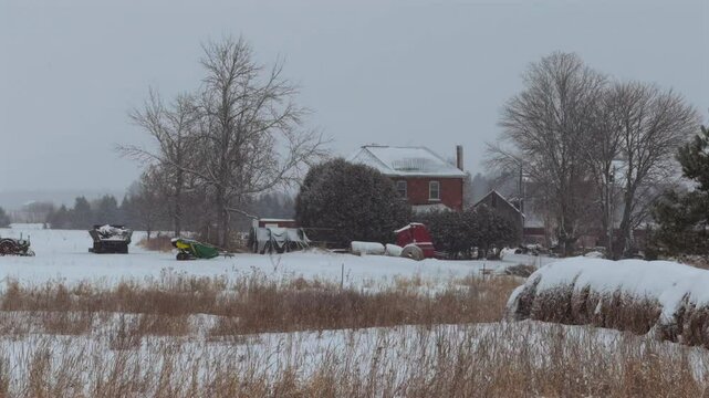 A farm house in a snow covered field