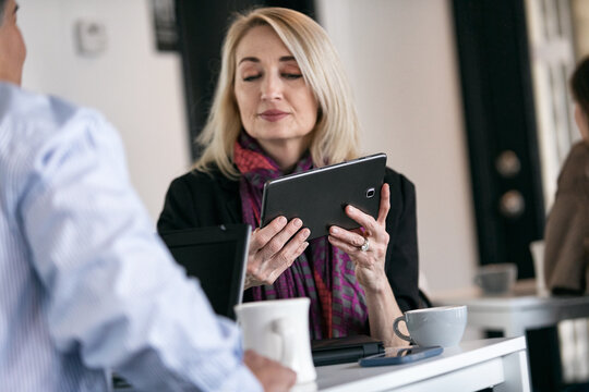 Business: Coworkers Discussing Graphics On Digital Tablet For Pr