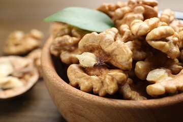 Peeled walnuts in bowl on table, closeup