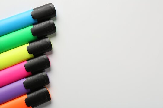 Bright highlighters on white background, flat lay. Space for text