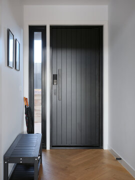Modern entryway with sleek black door and minimalist design