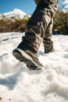 Close-up of hiker&rsquo;s legs walking on snow. winter outdoors