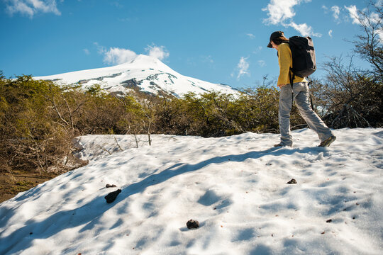 Hiker exploring snowy landscape with her backpack