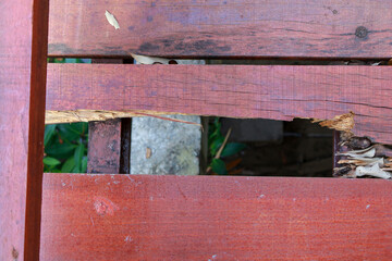 wooden bridge is damaged and has holes.