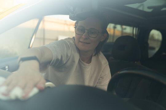 Woman Cleaning Car Dashboard with Cloth