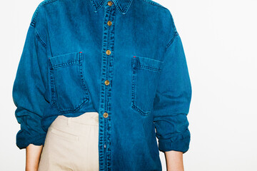 Person with denim shirt and formal trousers in office workplace