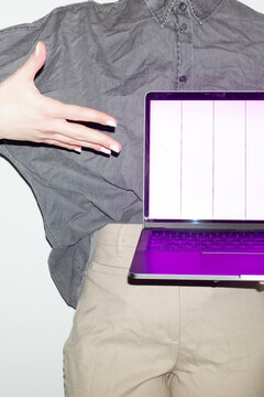 Person holding a laptop with broken screen in office workplace
