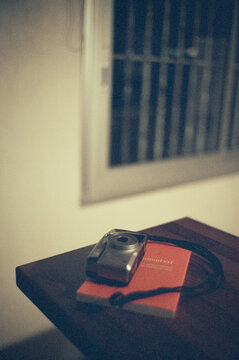 Vintage Camera on Red Book with Blurred Background