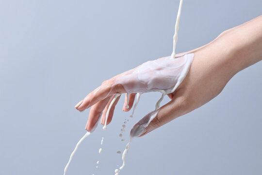 Fluid of milk flowing over a hand