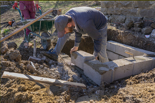 Block masons fit cinder blocks.