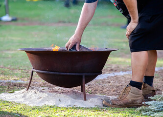 Ritual fire with green branch of eucalyptus, smoke and fire, the ritual rite at a indigenous community event in Australia
