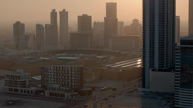 Bahrain, backlit skyscrapers in hazy warm afternoon light, Sanabis and Seef neighbourhoods