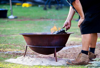 Ritual fire with green branch of eucalyptus, smoke and fire, the ritual rite at a indigenous community event in Australia