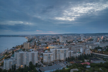 Obraz premium Saratov city, Russia. Aerial panoramic view to urban illuminated cityscape landscape at twilight