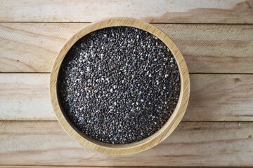 Chia seeds on brown wood background
