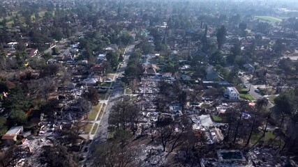 Aerial over Altadena neighborhood of destroyed homes from Eaton wildfire from powerful Santa Ana winds
