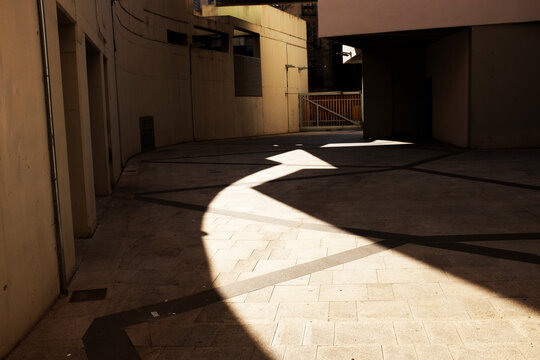 Conceptual shadowplay image: shadow and light creating arrow shape