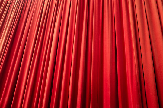 Red velvet silk fabric textile theatre show curtain and soft lighting 
