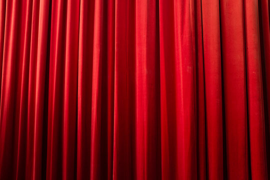 Red velvet silk fabric textile theatre show curtain and soft lighting 