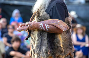 Australian aboriginal ceremony, human hand holds ritual clapsticks for the welcome rite at an indigenous reconciliation community event in Australia